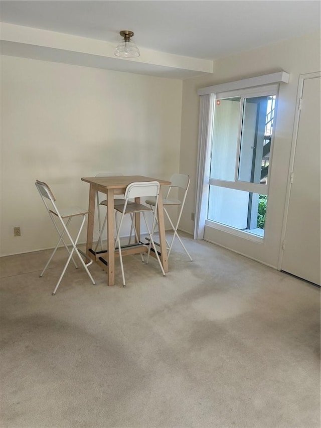 unfurnished dining area featuring light colored carpet