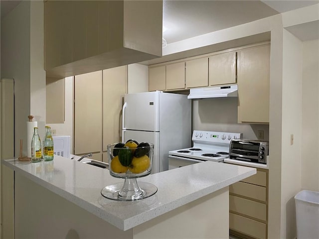 kitchen with white appliances, under cabinet range hood, a peninsula, and cream cabinetry