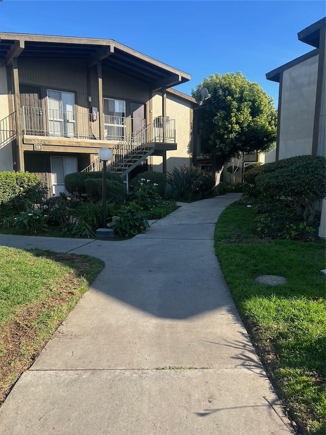 view of home's exterior with a lawn and stucco siding