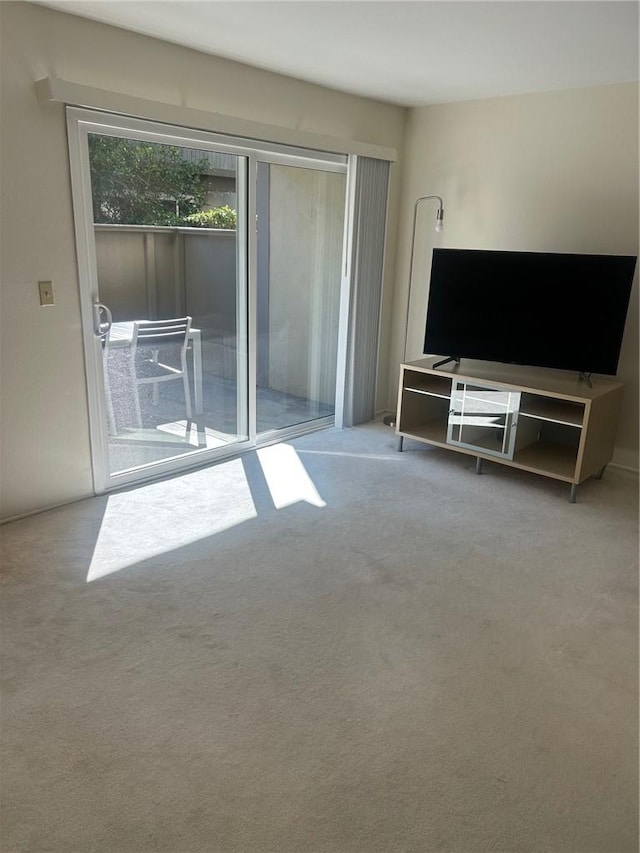 unfurnished living room featuring light colored carpet