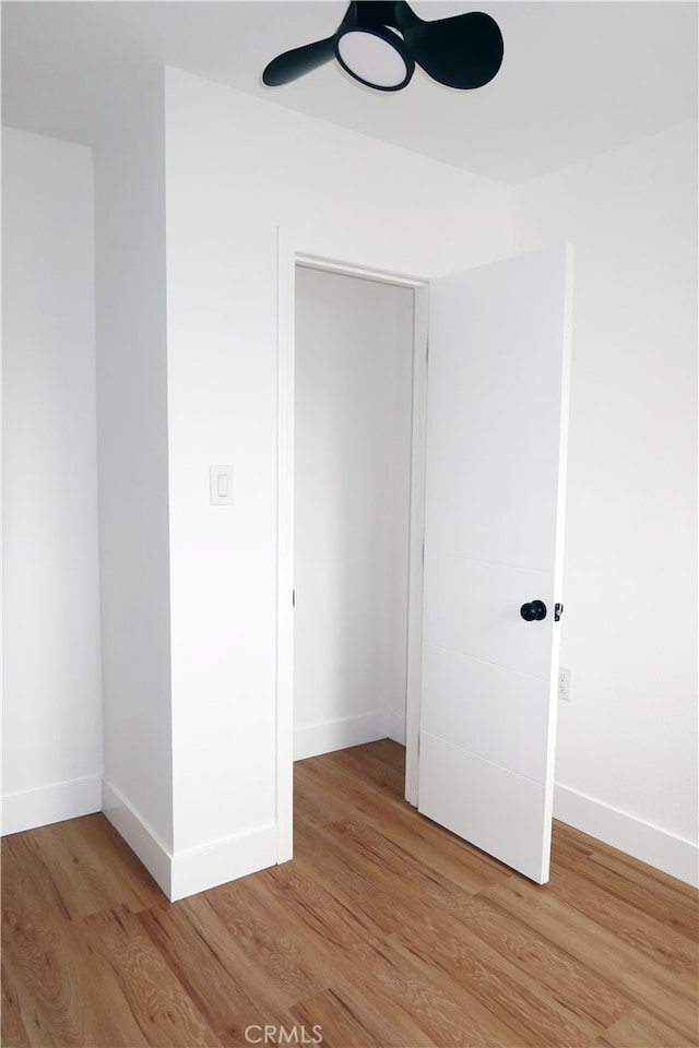 empty room featuring light hardwood / wood-style flooring and ceiling fan