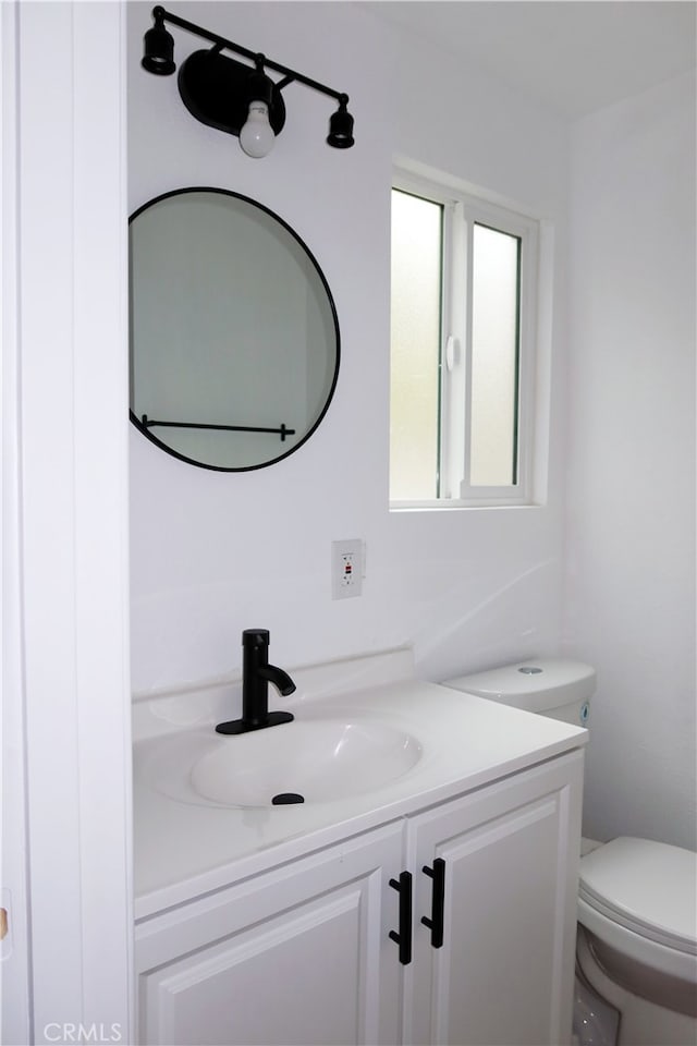 bathroom with vanity and toilet