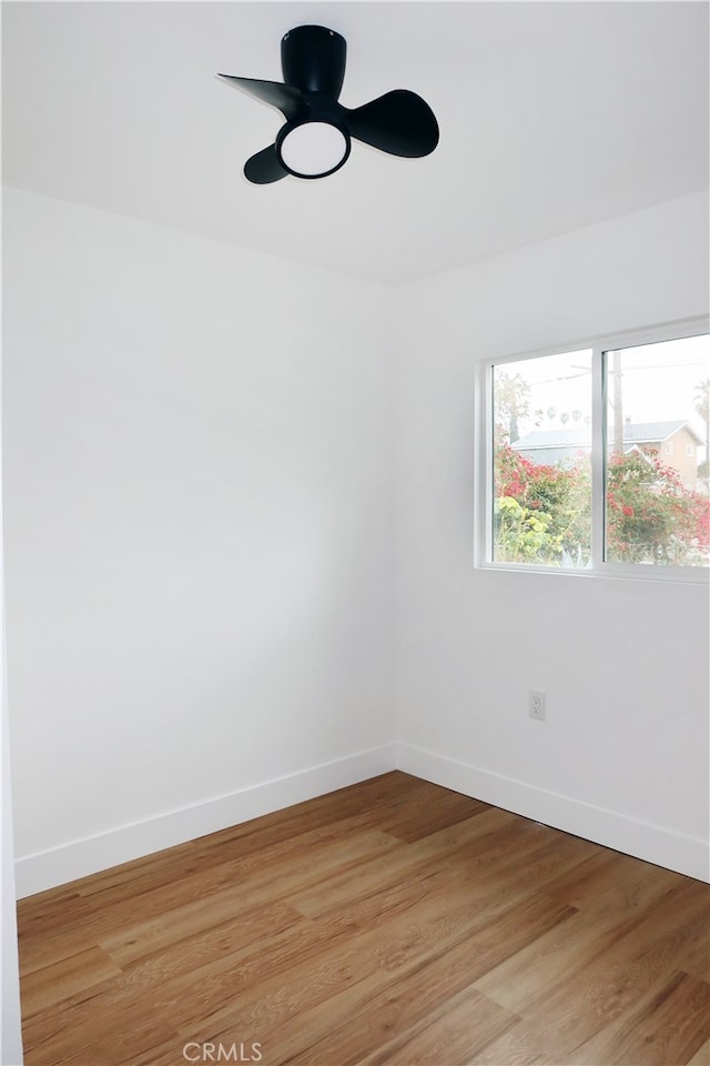 empty room featuring ceiling fan and light hardwood / wood-style flooring