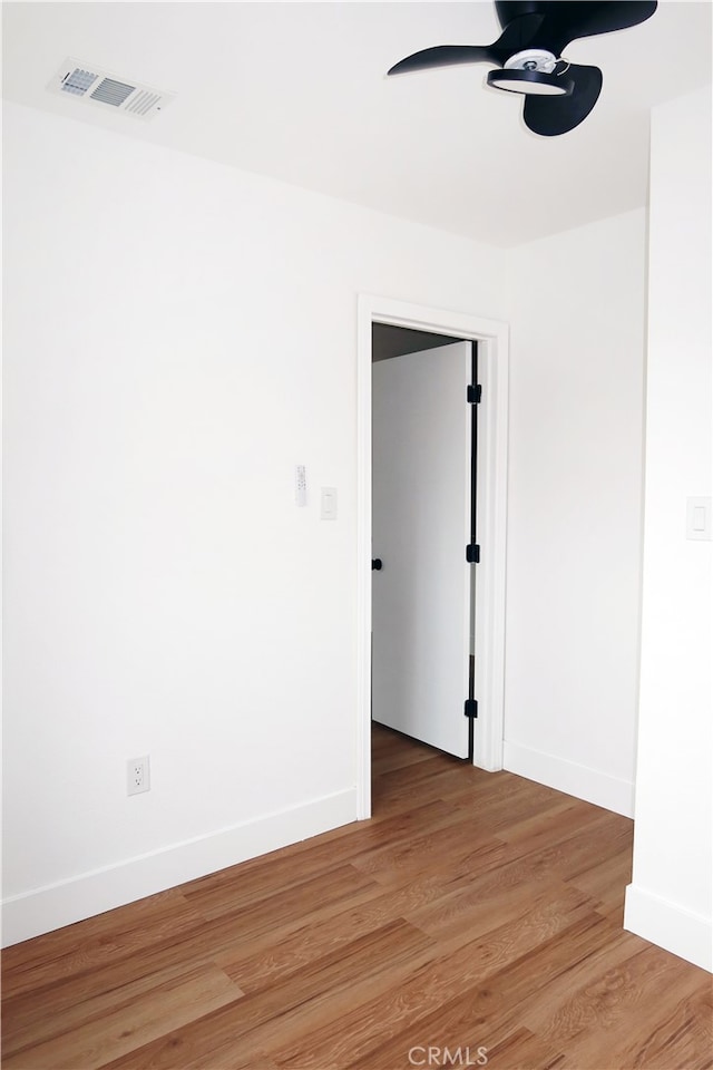 unfurnished room featuring ceiling fan and hardwood / wood-style floors