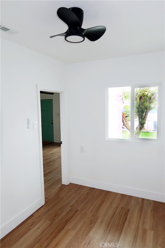 unfurnished room with ceiling fan and hardwood / wood-style floors