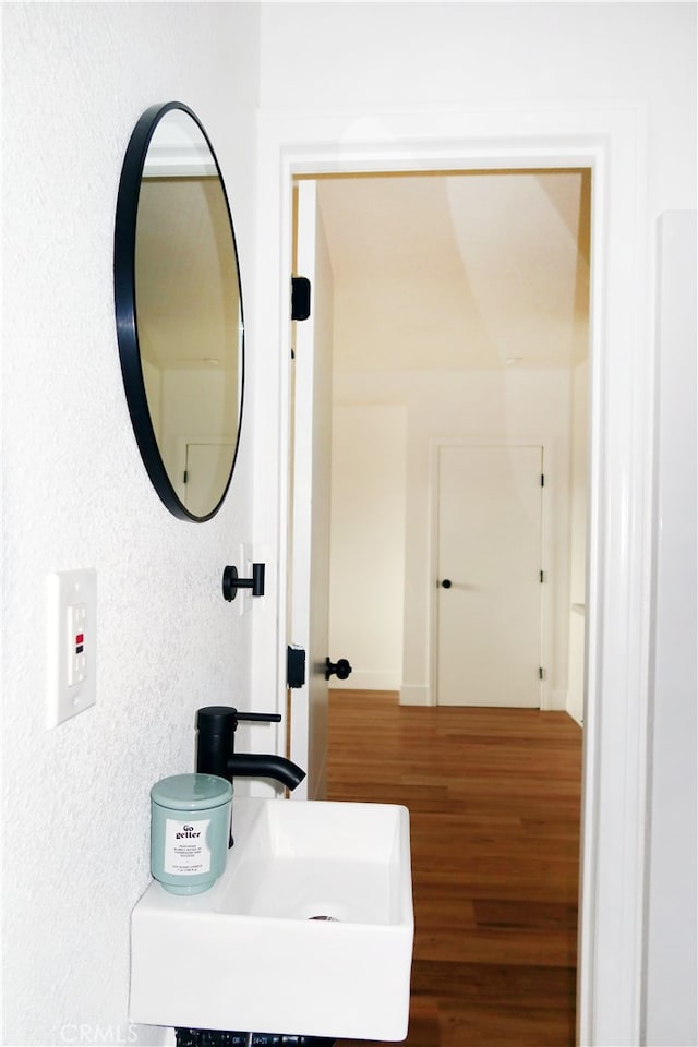 bathroom with sink and hardwood / wood-style flooring