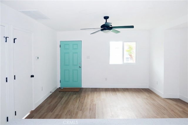 empty room featuring ceiling fan and light hardwood / wood-style flooring