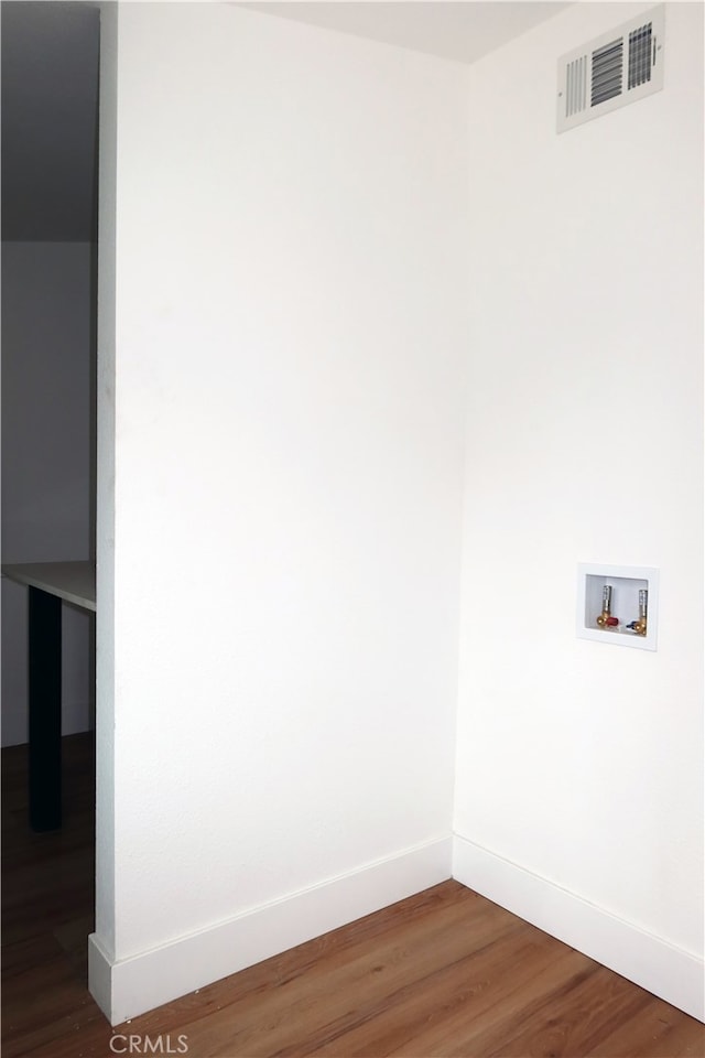 washroom featuring dark wood-type flooring and hookup for a washing machine