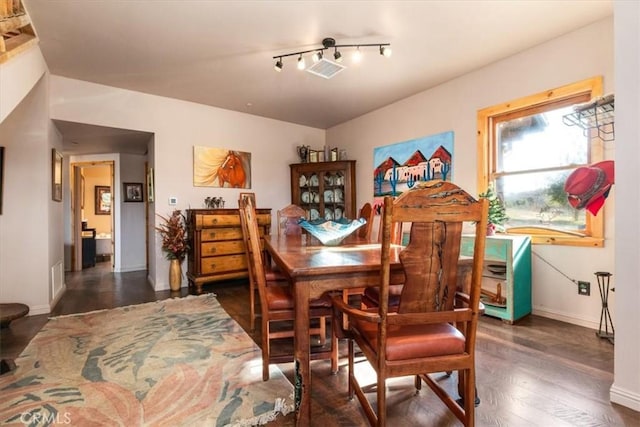 dining room featuring visible vents, baseboards, and dark wood-type flooring