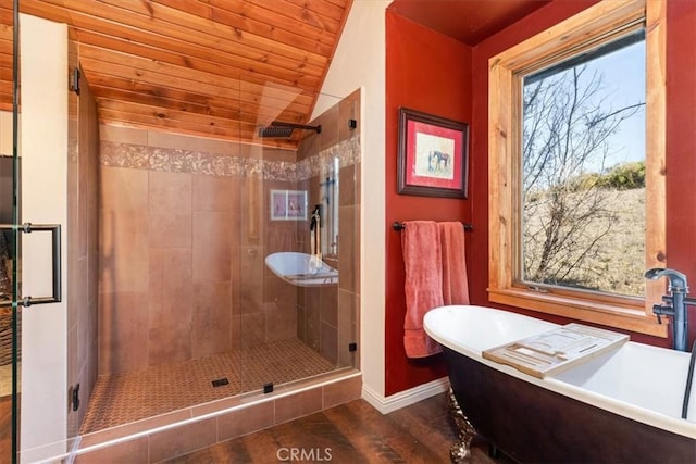 full bathroom featuring lofted ceiling, wooden ceiling, wood finished floors, a freestanding bath, and a stall shower