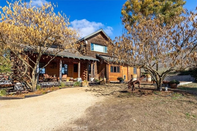 log cabin featuring covered porch