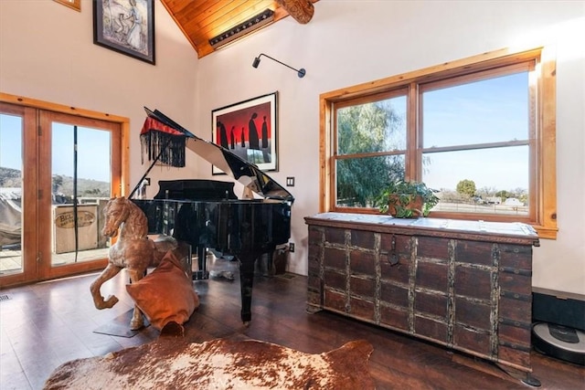 sitting room featuring a healthy amount of sunlight, wooden ceiling, and vaulted ceiling