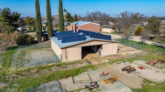 view of outbuilding with an outbuilding, solar panels, and an exterior structure