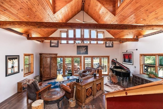 living room featuring a healthy amount of sunlight, wooden ceiling, wood finished floors, and beamed ceiling