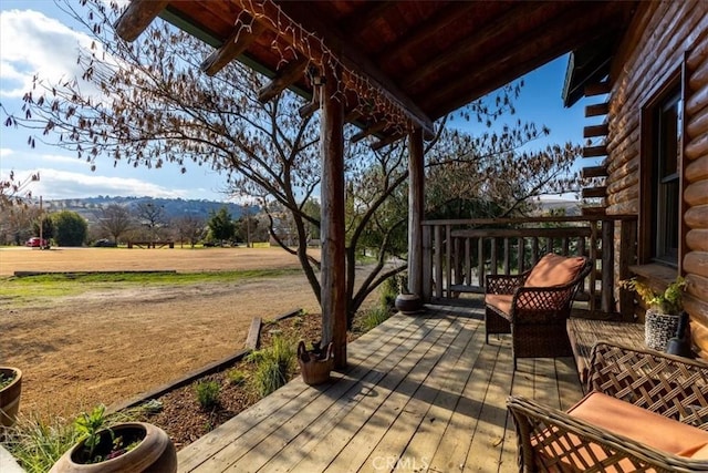 wooden terrace with a mountain view and a rural view