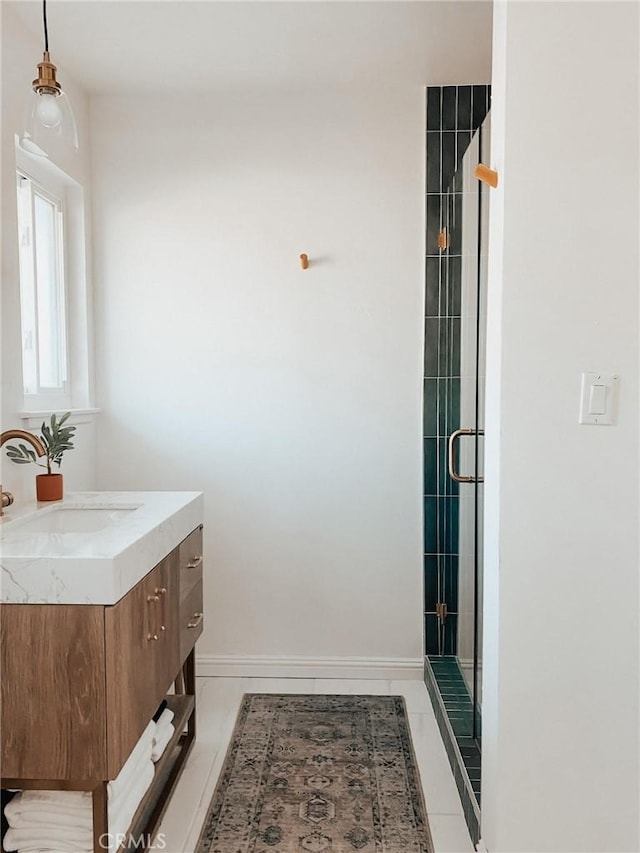 bathroom with vanity, an enclosed shower, and tile patterned floors