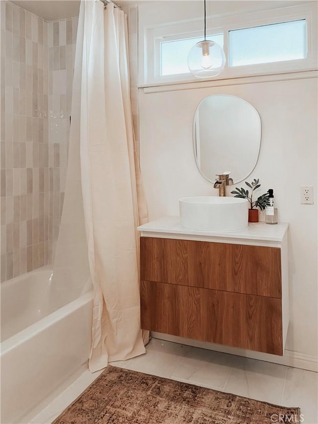 bathroom with vanity, shower / bathtub combination with curtain, and tile patterned floors