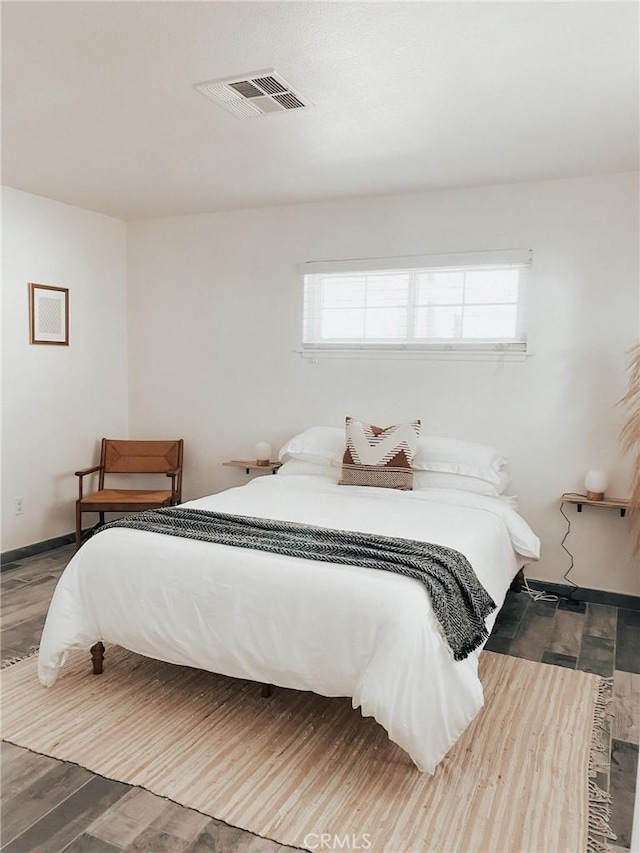 bedroom featuring hardwood / wood-style floors and multiple windows