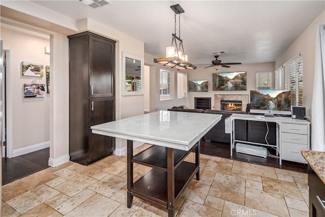 kitchen featuring dark brown cabinetry, decorative light fixtures, and ceiling fan