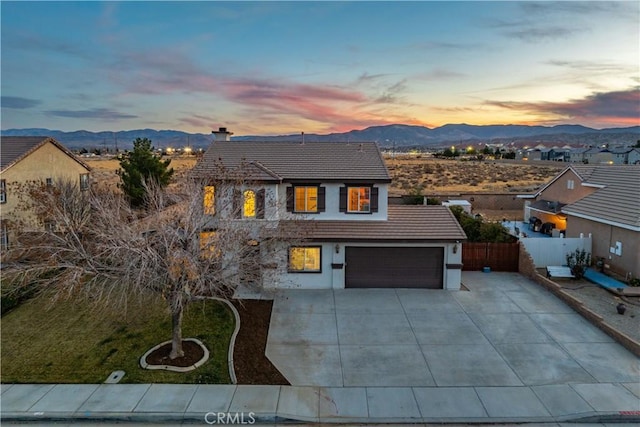 view of front of home with a garage and a mountain view