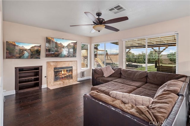 living room with a fireplace, dark hardwood / wood-style floors, and ceiling fan