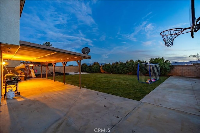 patio terrace at dusk with a yard and a playground