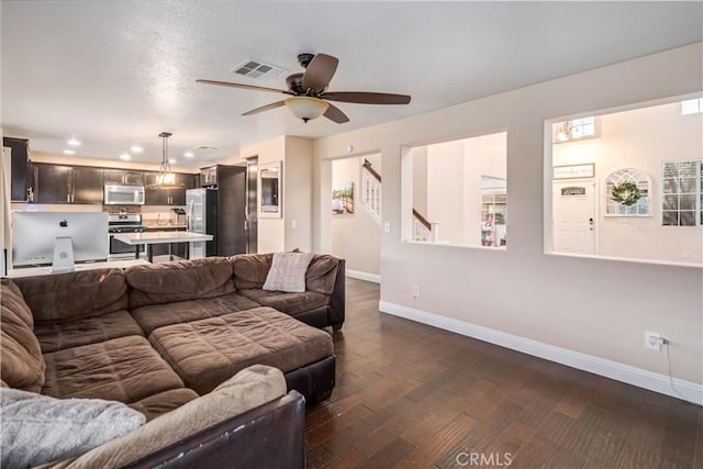 living room featuring dark hardwood / wood-style floors and ceiling fan