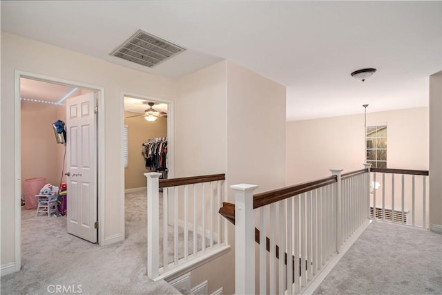 hallway featuring light carpet