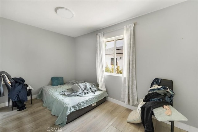 bedroom with wood-type flooring