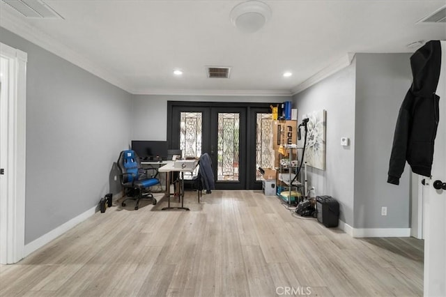 office featuring crown molding, light hardwood / wood-style flooring, and french doors