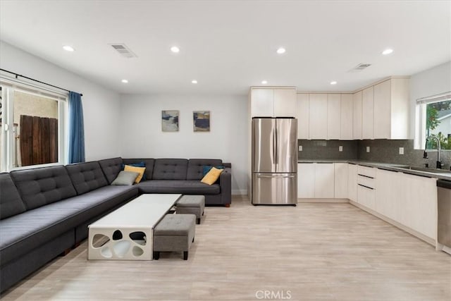 interior space with sink and light hardwood / wood-style flooring