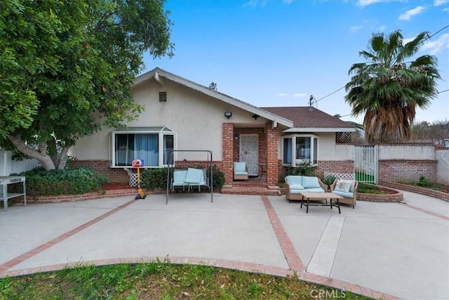 back of house with an outdoor hangout area and a patio area