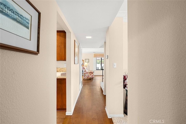 hallway with hardwood / wood-style flooring