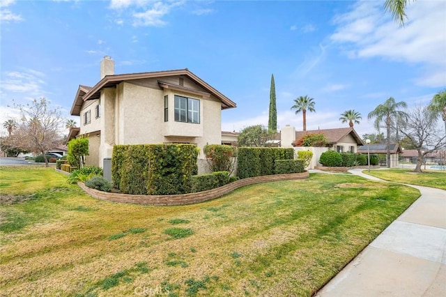 view of side of property featuring a lawn