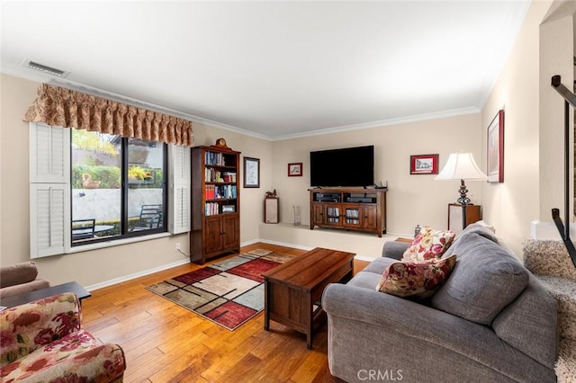 living room with crown molding and wood-type flooring