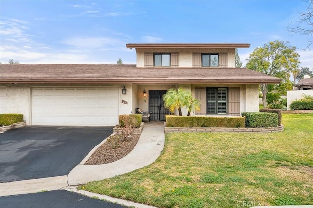 view of property featuring a garage and a front yard