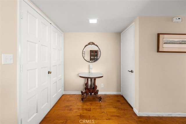 hall with hardwood / wood-style floors