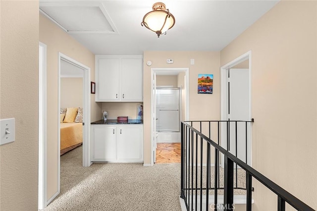 hallway featuring light carpet