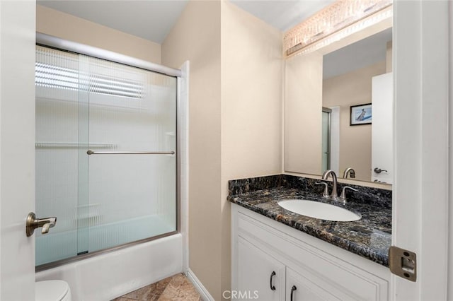 full bathroom with vanity, shower / bath combination with glass door, and toilet