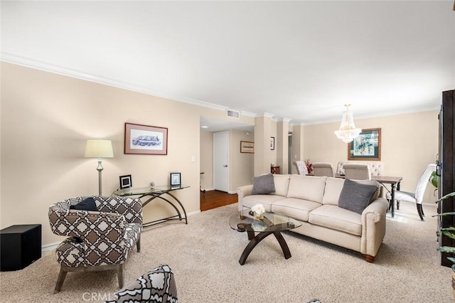 carpeted living room featuring ornamental molding and an inviting chandelier