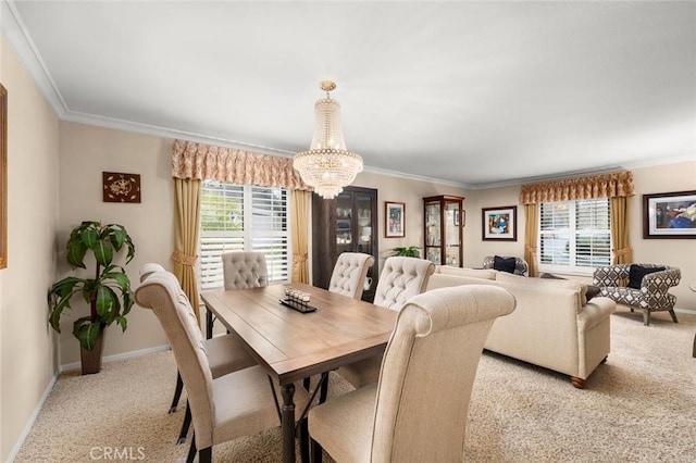 carpeted dining room featuring an inviting chandelier, crown molding, and a healthy amount of sunlight