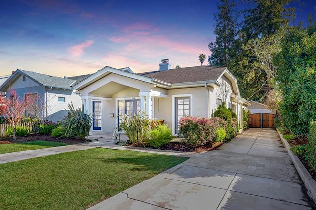 bungalow-style home with a yard