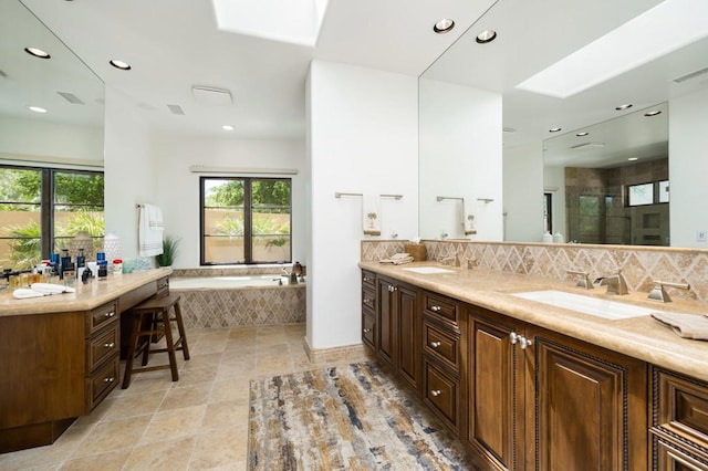 bathroom featuring vanity, a skylight, and plenty of natural light