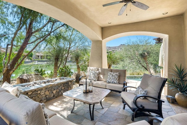 view of patio / terrace with outdoor lounge area, ceiling fan, and a water view