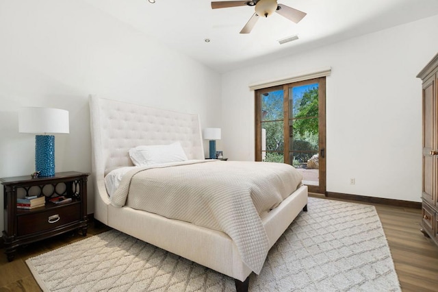 bedroom featuring dark hardwood / wood-style floors, access to exterior, and ceiling fan