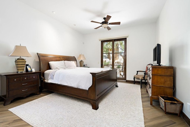 bedroom featuring access to exterior, hardwood / wood-style flooring, and ceiling fan