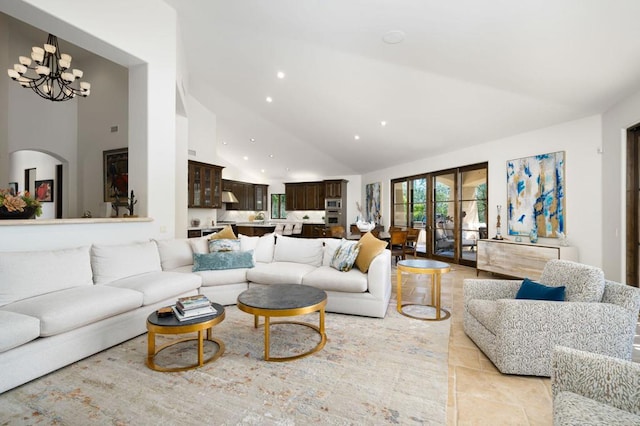 living room featuring an inviting chandelier and high vaulted ceiling