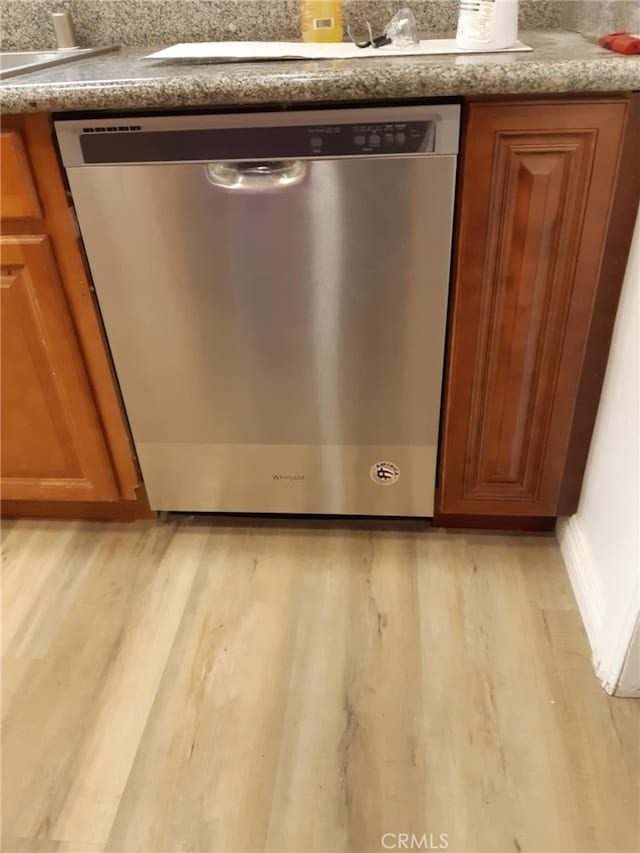 details with light hardwood / wood-style flooring and dishwasher