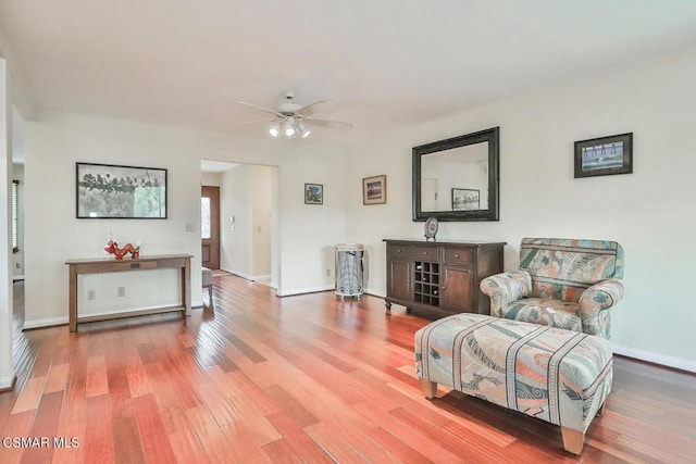 sitting room with light hardwood / wood-style flooring and ceiling fan