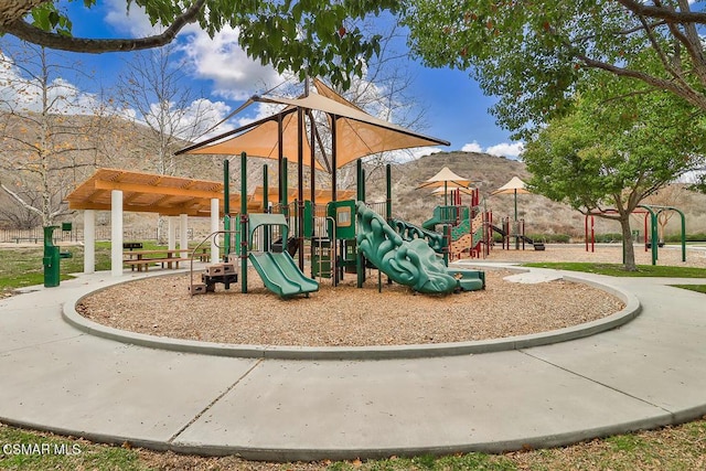 view of jungle gym featuring a mountain view